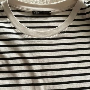 Women’s black and white striped muscle tee with shoulder pads.